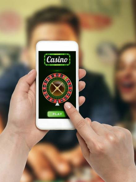 Online gambling, casino concept. Hand holding device with lottery, casino cover